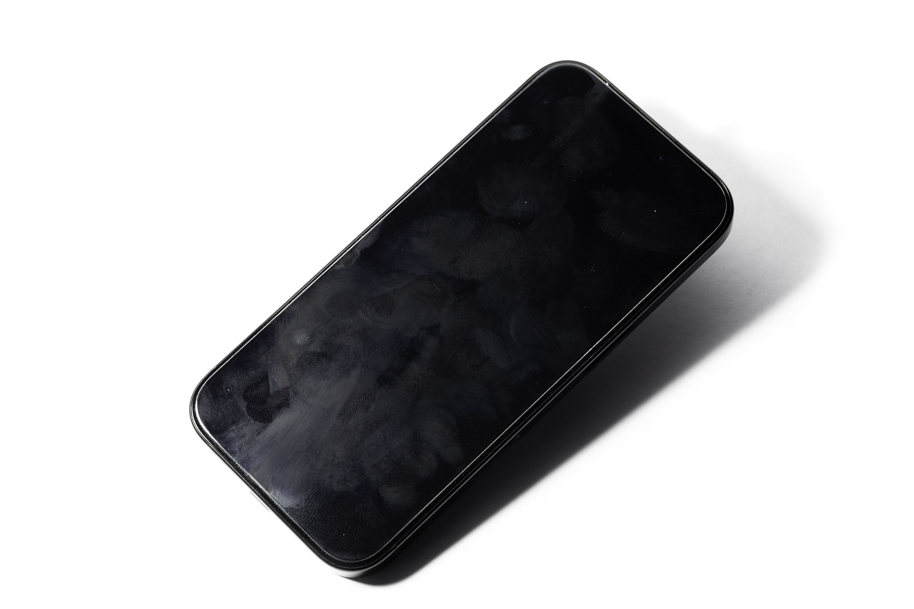 an angled, smudged smartphone on a white background